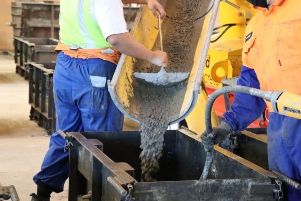 High-quality excess concrete being added to a Interbloc mould